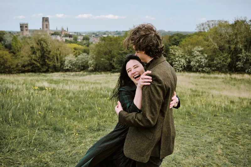 A newly engaged couple embracing after a surprise proposal in Durham
