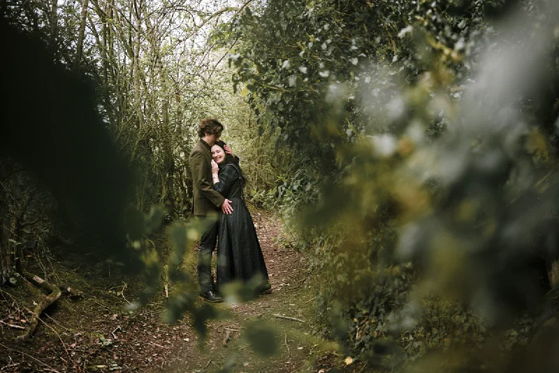 A quiet portrait of a newly engaged couple among the trees in Durham